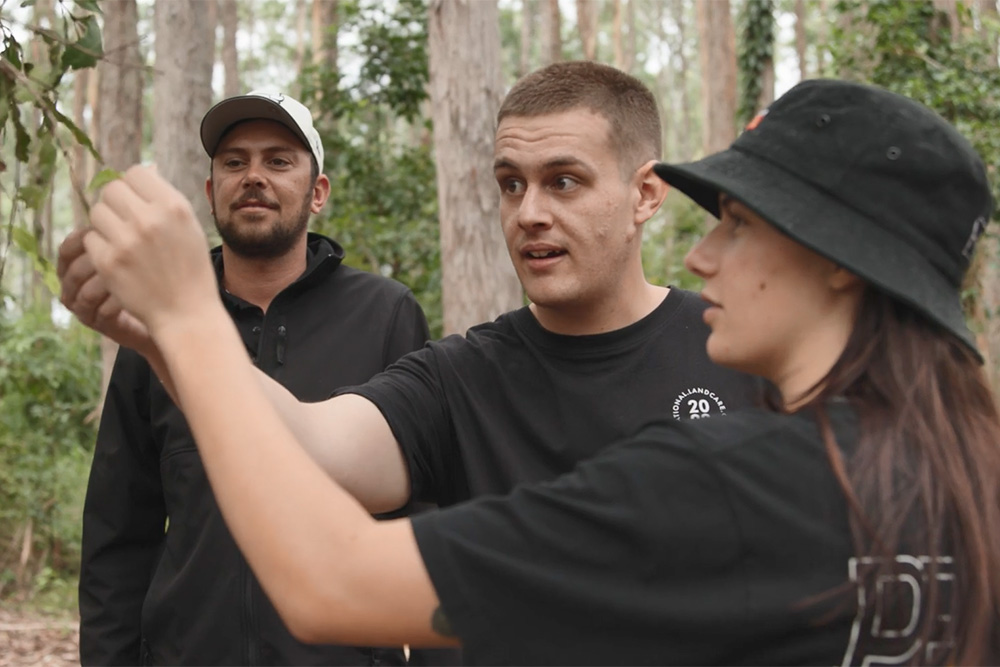 Still from ‘Roots of Resilience’ - Gumbaynggirr Country (left to right) AJ Perkins, Department of Planning and Environment (NSW). Corey Williams, Department of Agriculture, Fisheries and Forestry. Tilly Davis, Department of Planning and Environment (NSW).