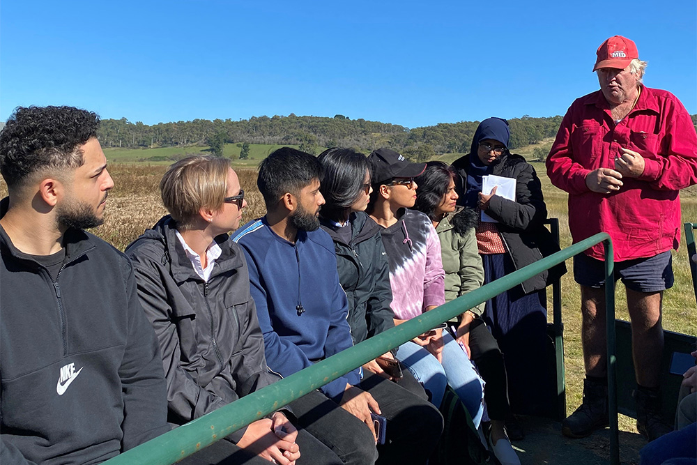 Image of Gary Kadwell in red from Kadwell & Co Gourmet Potatoes farm in Crookwell explaining regenerative farming to departmental staff. 