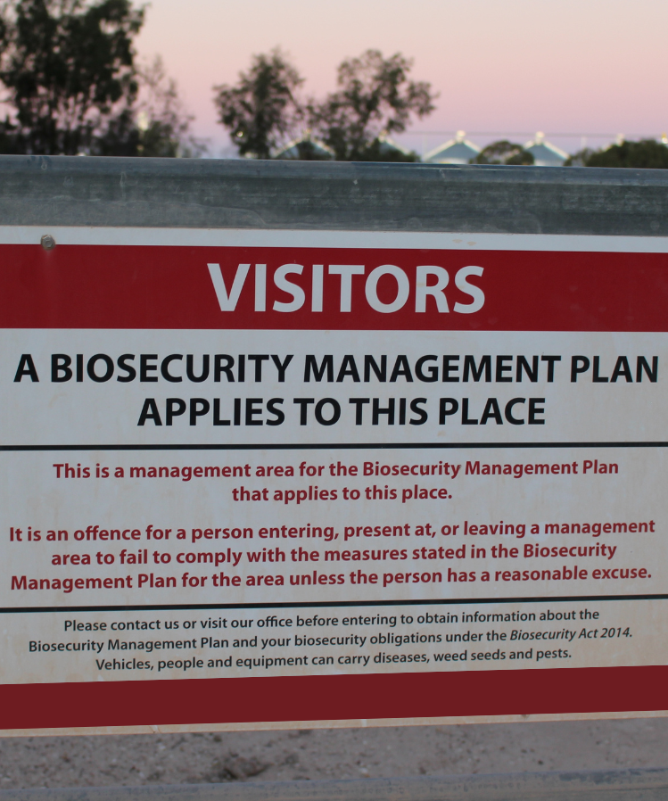 Sign on farm gate alerting visitors to biosecurity requirements