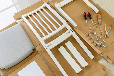 Image of flatpack chair on top of cardboard packaging, ready for construction.