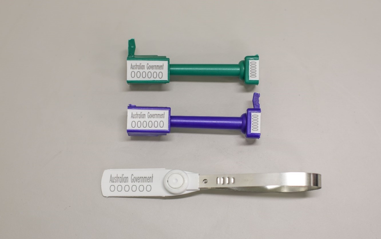 Image of three rectangular-style labels, one green, one purple/blue, one silver; they have "Australian Government" printed on them and the number 00000