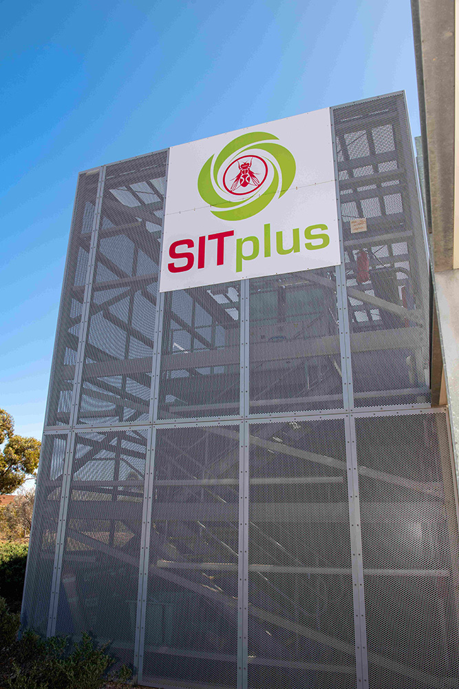 Image of a large metal building with a sign saying "SITplus"