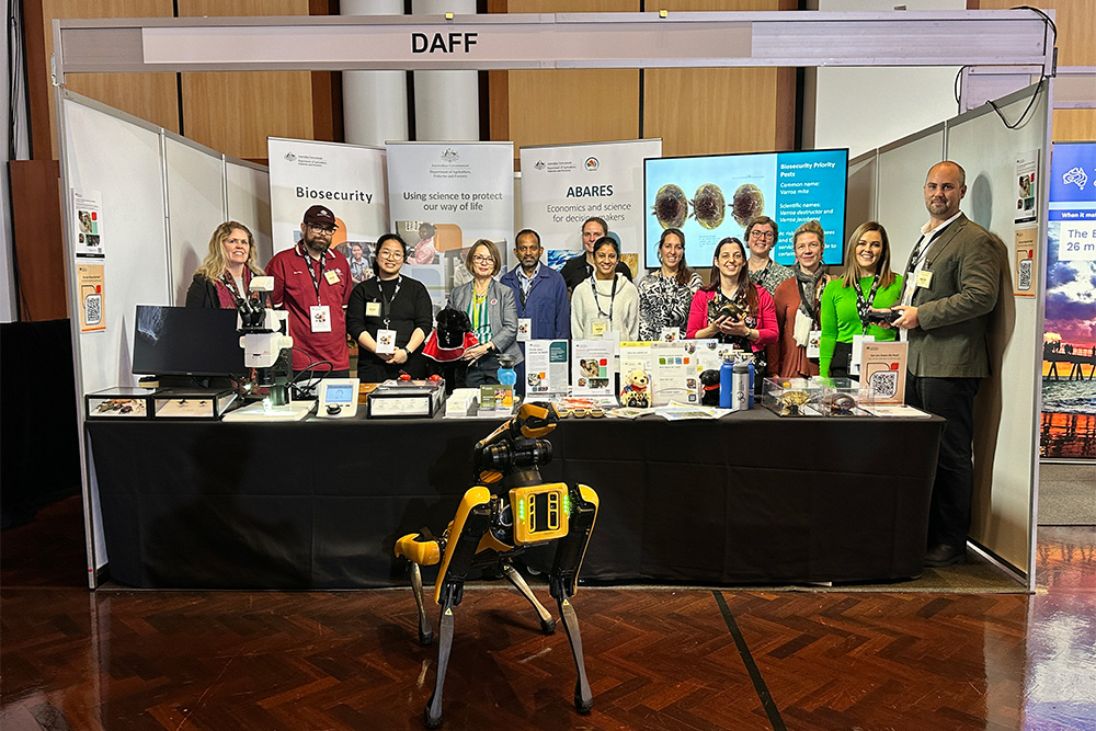 Image of a group of people posing in an exhibition booth