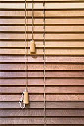 Image of Venetian-style shutter blinds constructed from thin wooden slats.