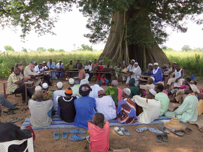 Photo of a group of village people meeting to discuss animal health.