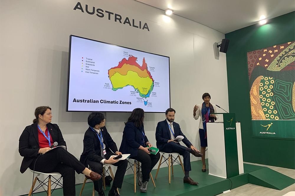 Image of a group of people sitting on a panel and giving a presentation